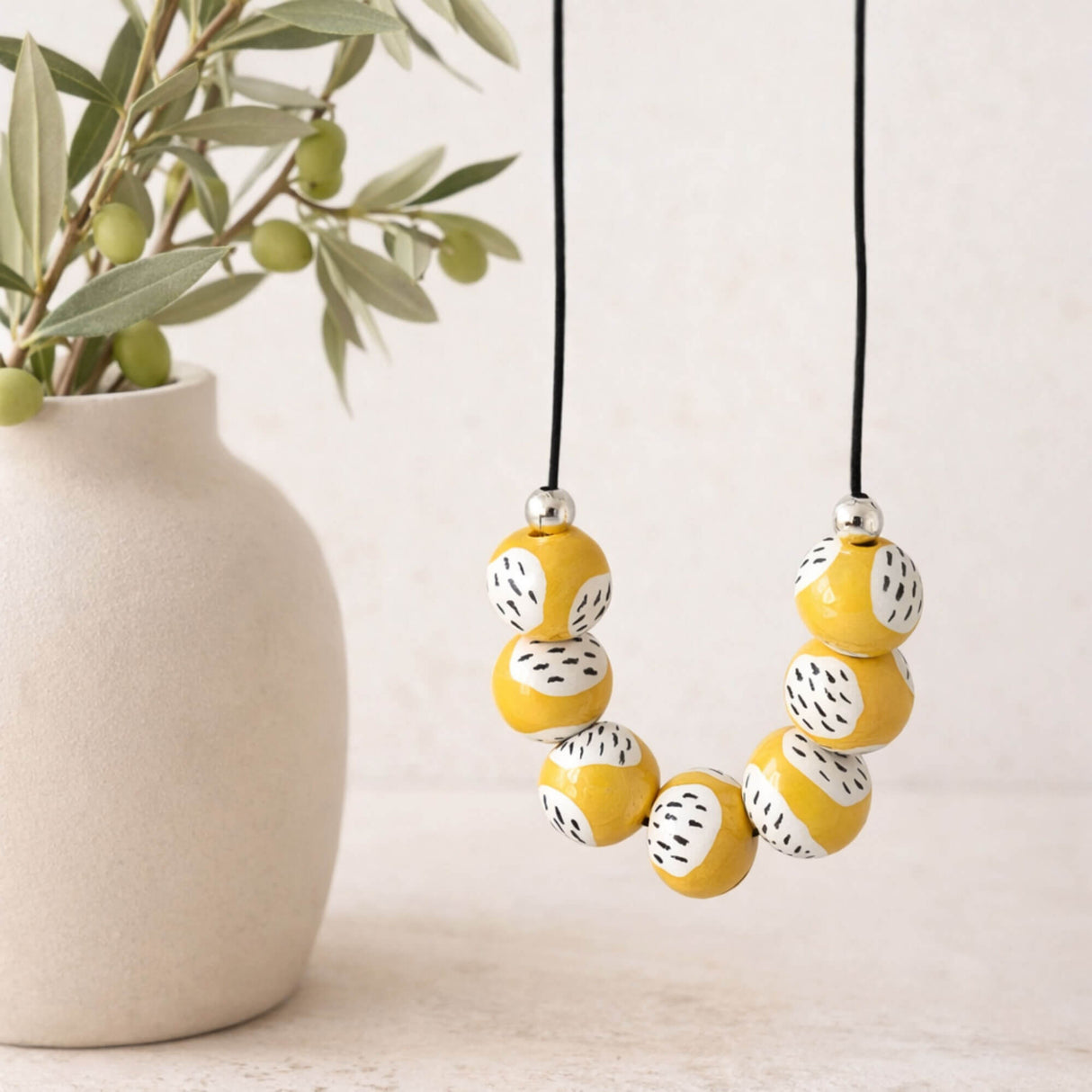 yellow modern bead necklace, handmade clay jewellery at lottie of london, lifestyle image