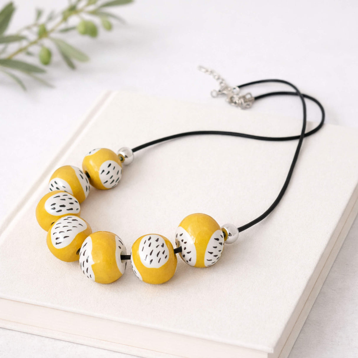 yellow clay bead necklace, handmade jewellery at lottie of london, flay lay image