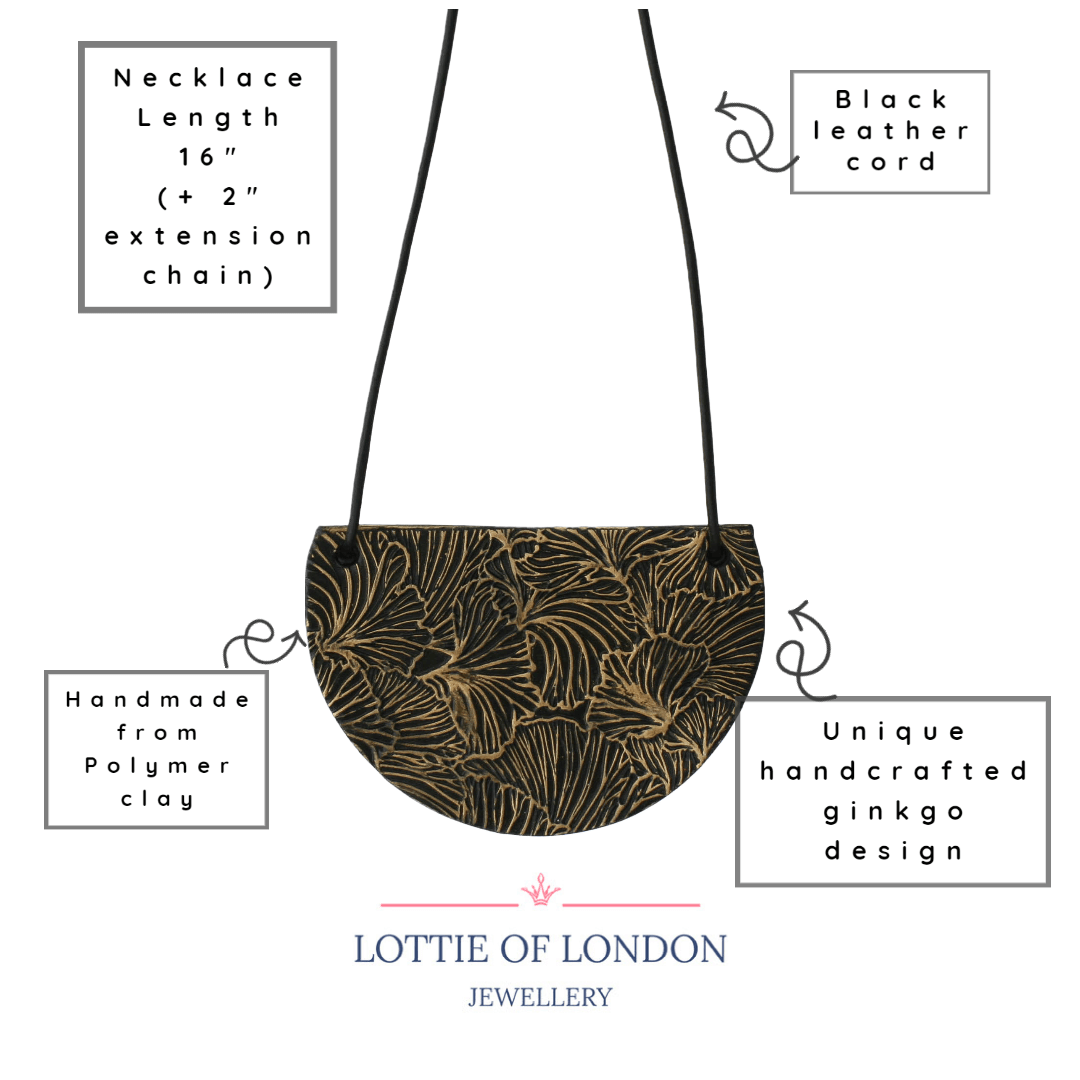 Black bib pendant necklace with gold ginkgo design