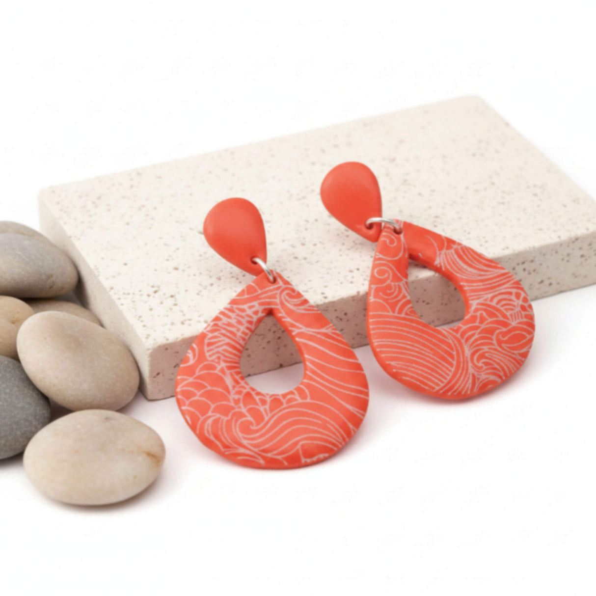 orange statement teardrop earrings on stone plinth - handmade jewellery at lottie of london 