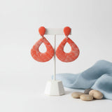 orange statement teardrop earrings on earrings stand - handmade jewellery at lottie of london 