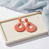 orange statement drop earrings lifestyle image - handmade jewellery at lottie of london 