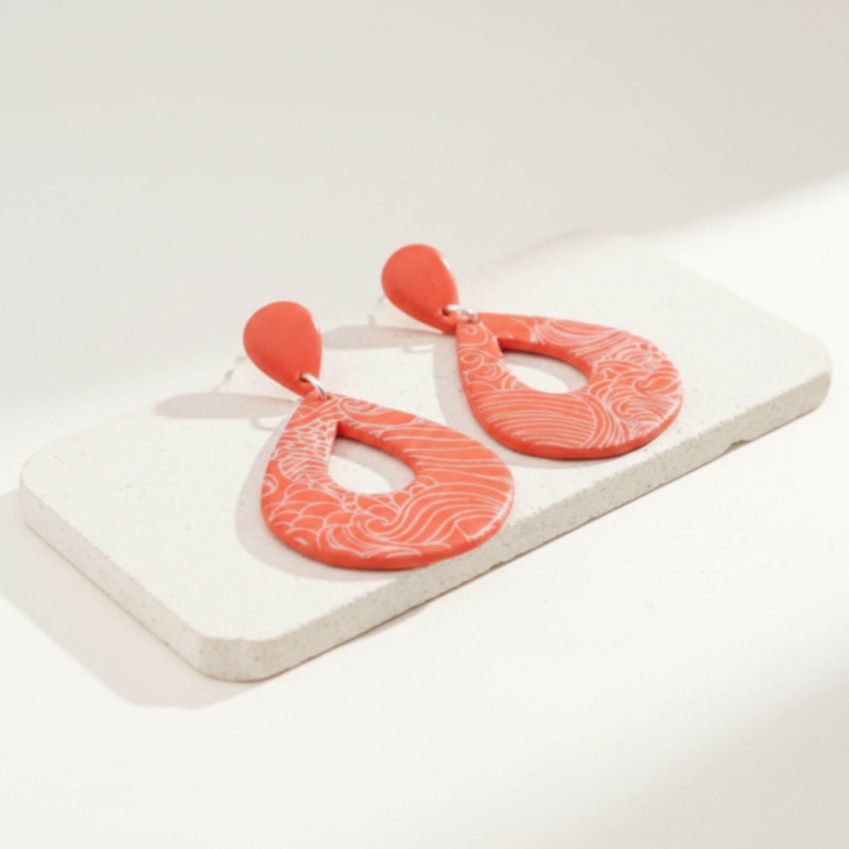 large orange statement drop earrings on stone plinth - handmade jewellery at lottie of london 