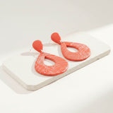 large orange statement drop earrings on stone plinth - handmade jewellery at lottie of london 