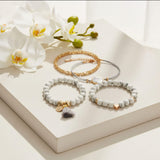 white and grey layered bracelet stack lifestyle shot at Lottie of London