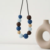 blue & brown statement necklace, handmade clay jewellery at lottie of london, lifestyle image