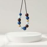 blue & brown chunky statement necklace, handmade clay jewellery at lottie of london, lifestyle image