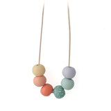 Long adjustable necklace with colorful beads on a white background