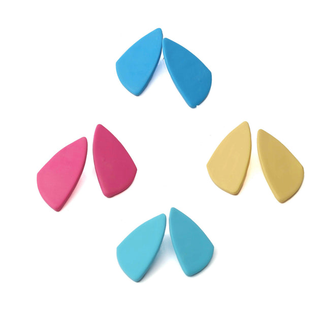 Colorful geometric statement stud earrings on a white background