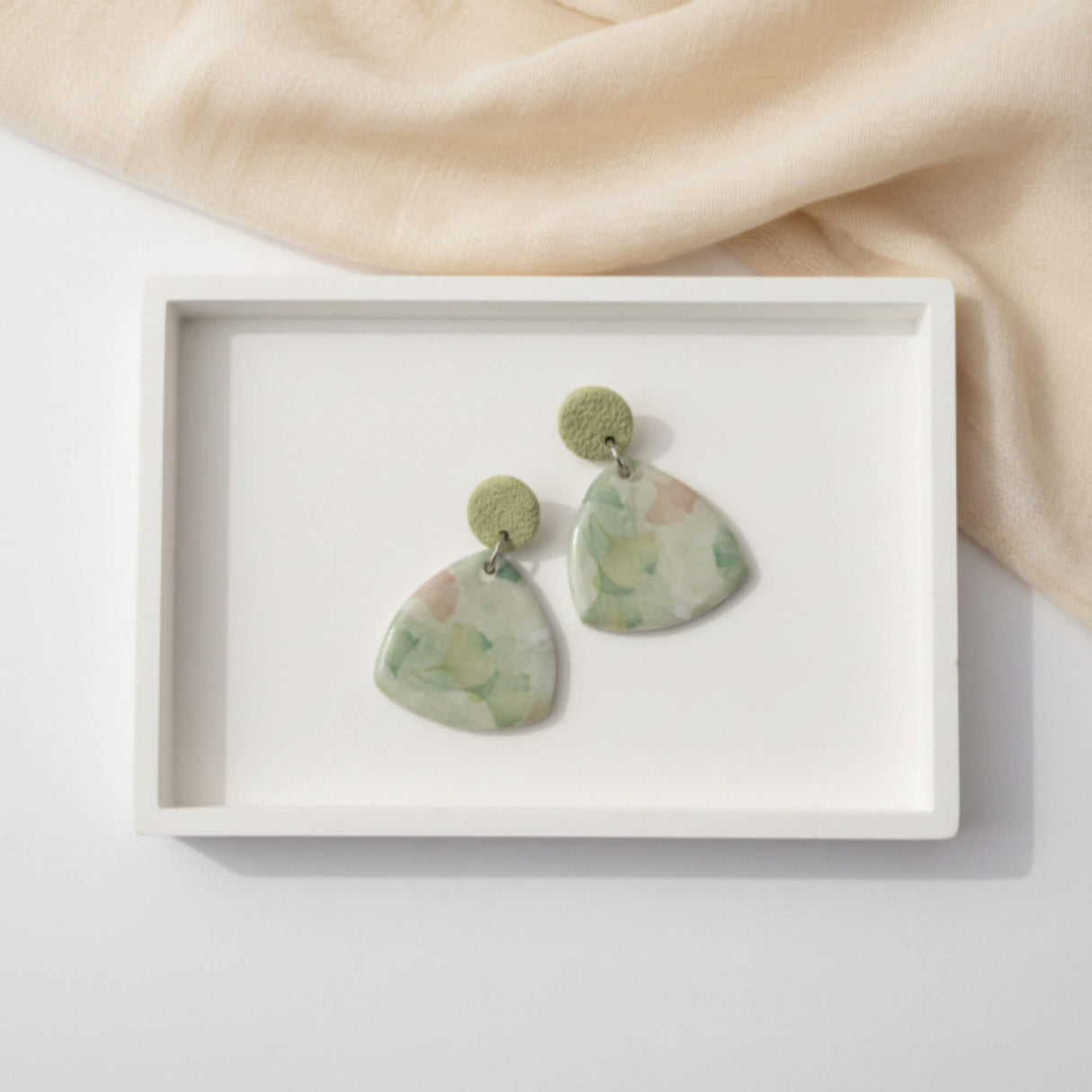 Green drop earrings, flat lay image, handmade jewellery at lottie of london