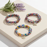 Multi-Colour Beaded Bracelet Stack with Gold Charms – lifestyle image - Layered Bracelet Set - Lottie Of London Jewellery