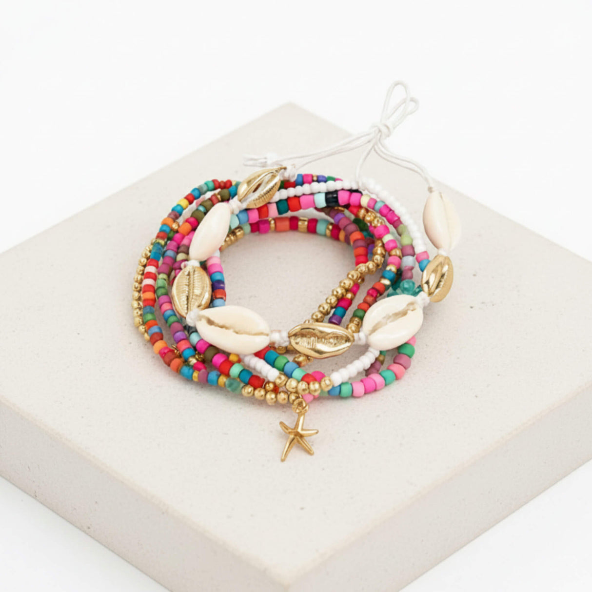 Colourful seed bead and cowrie shell stacking bracelet at Lottie Of London