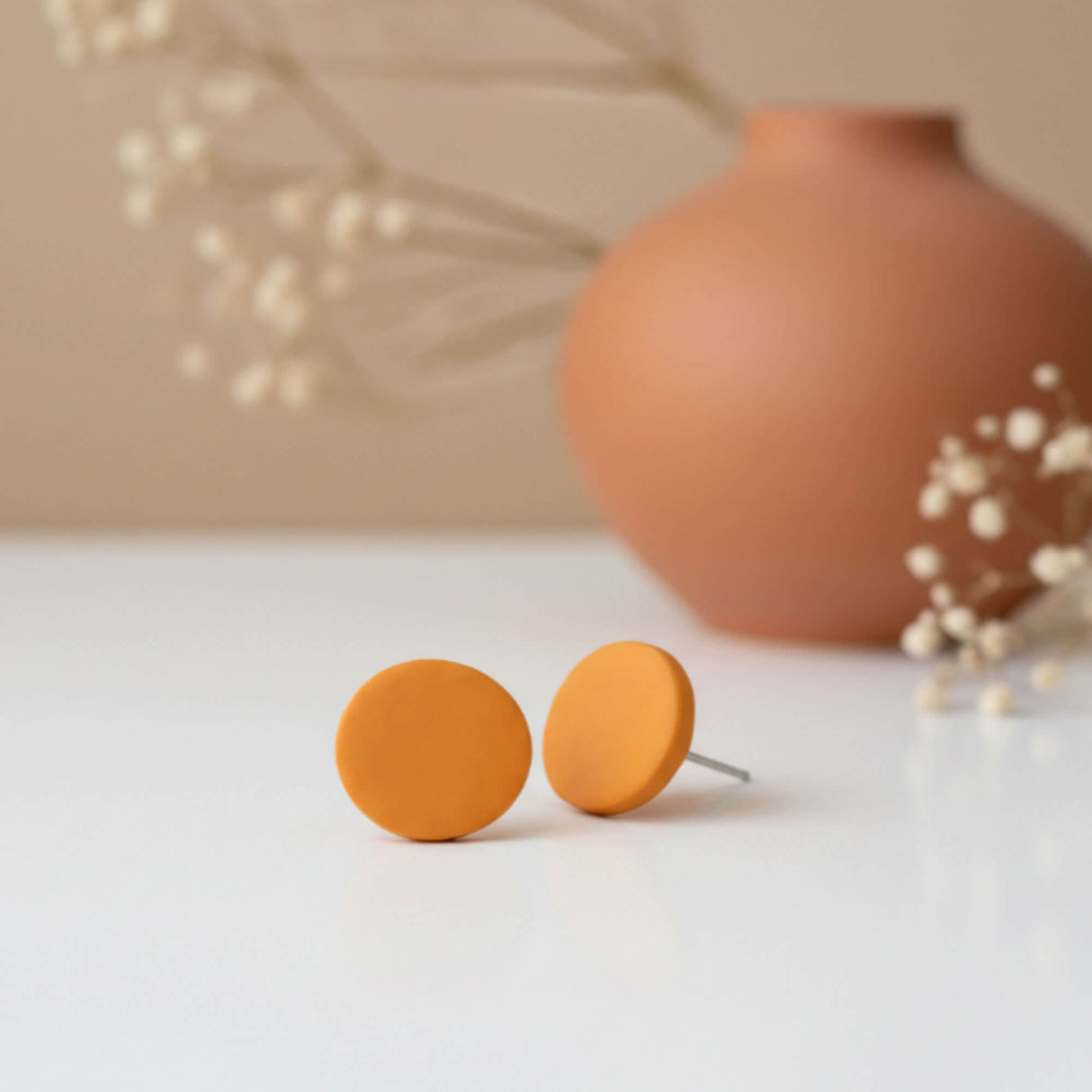 Mustard yellow stud earrings, lifestyle image, handmade clay jewellery at Lottie of London