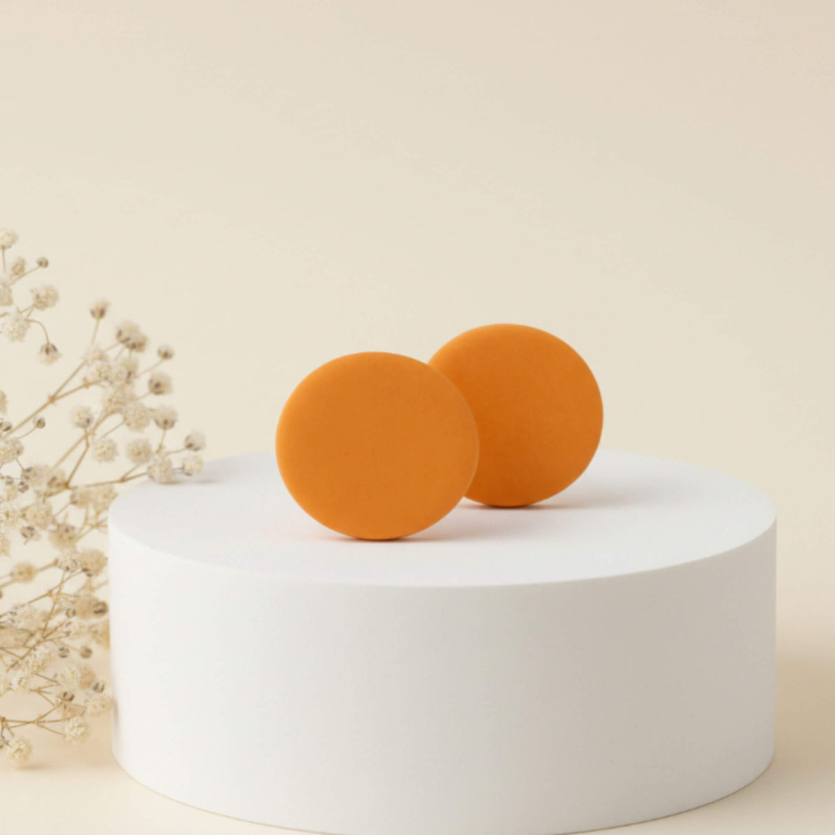 yellow stud earrings on a plinth, handmade clay jewellery at Lottie of London