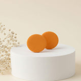 yellow stud earrings on a plinth, handmade clay jewellery at Lottie of London