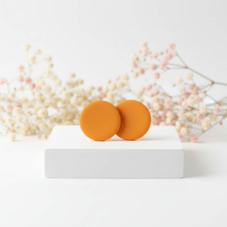 Mustard yellow small stud earrings, styled image, handmade clay jewellery at Lottie of London