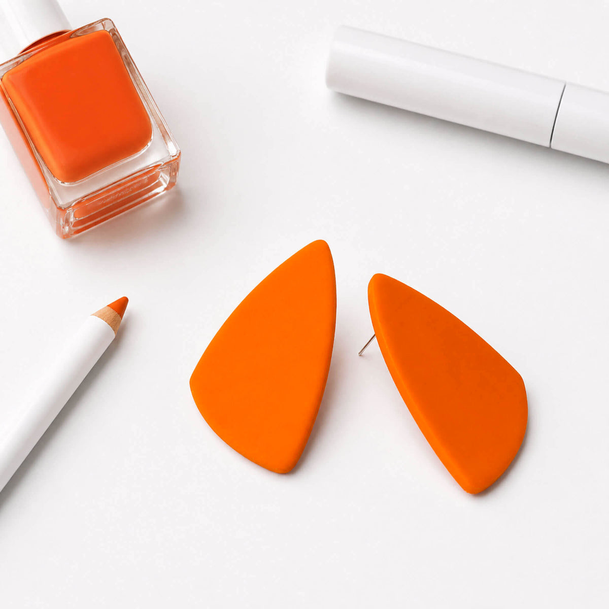bright orange statement stud earrings,  handmade clay jewellery at Lottie of London, lifestyle image