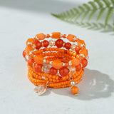 Orange stacking bracelet lifestyle at lottie of london uk