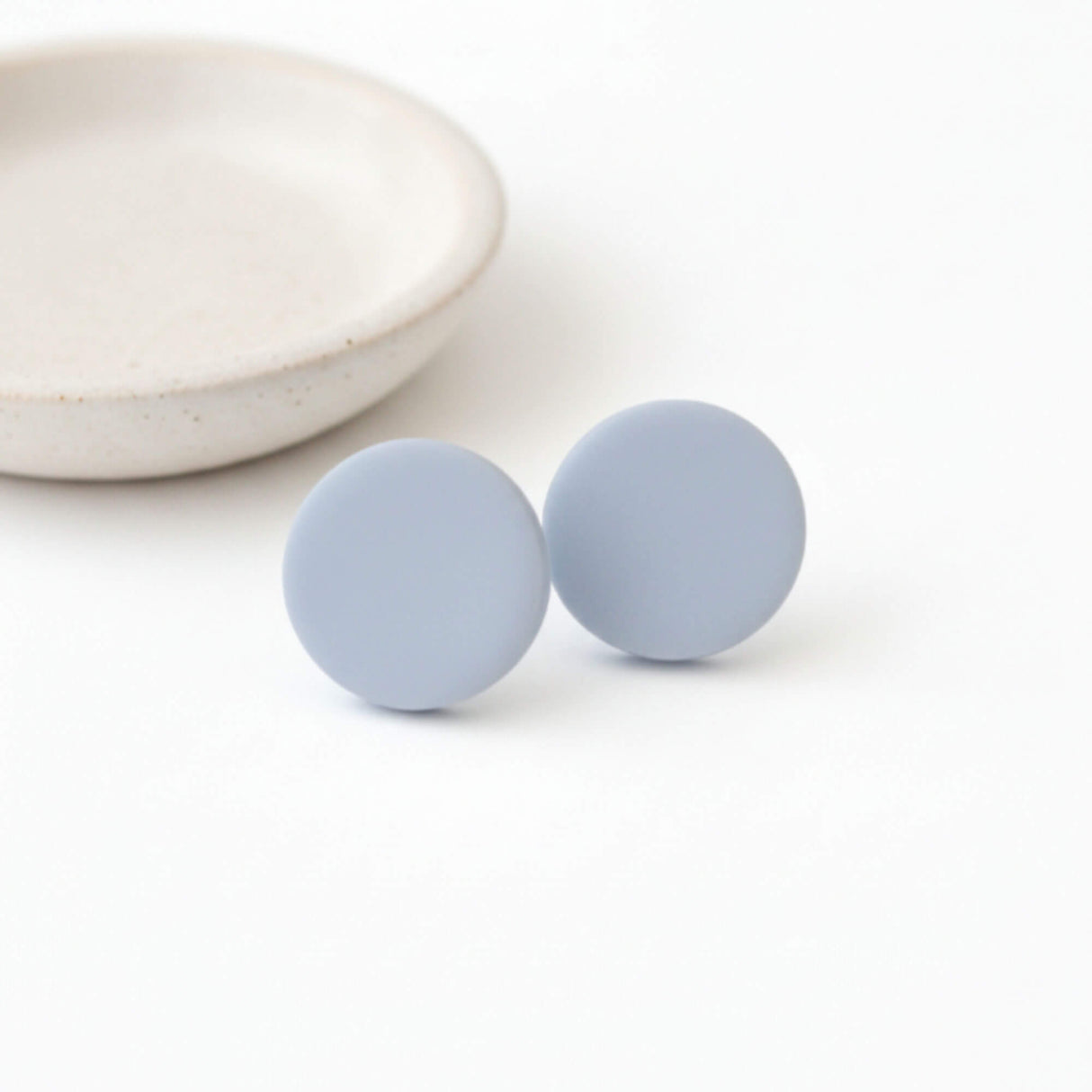 Large Pale Blue Clay Stud Earrings on flat lay – Minimalist Handmade Jewellery - Lottie Of London Jewellery