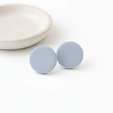 Large Pale Blue Clay Stud Earrings on flat lay – Minimalist Handmade Jewellery - Lottie Of London Jewellery