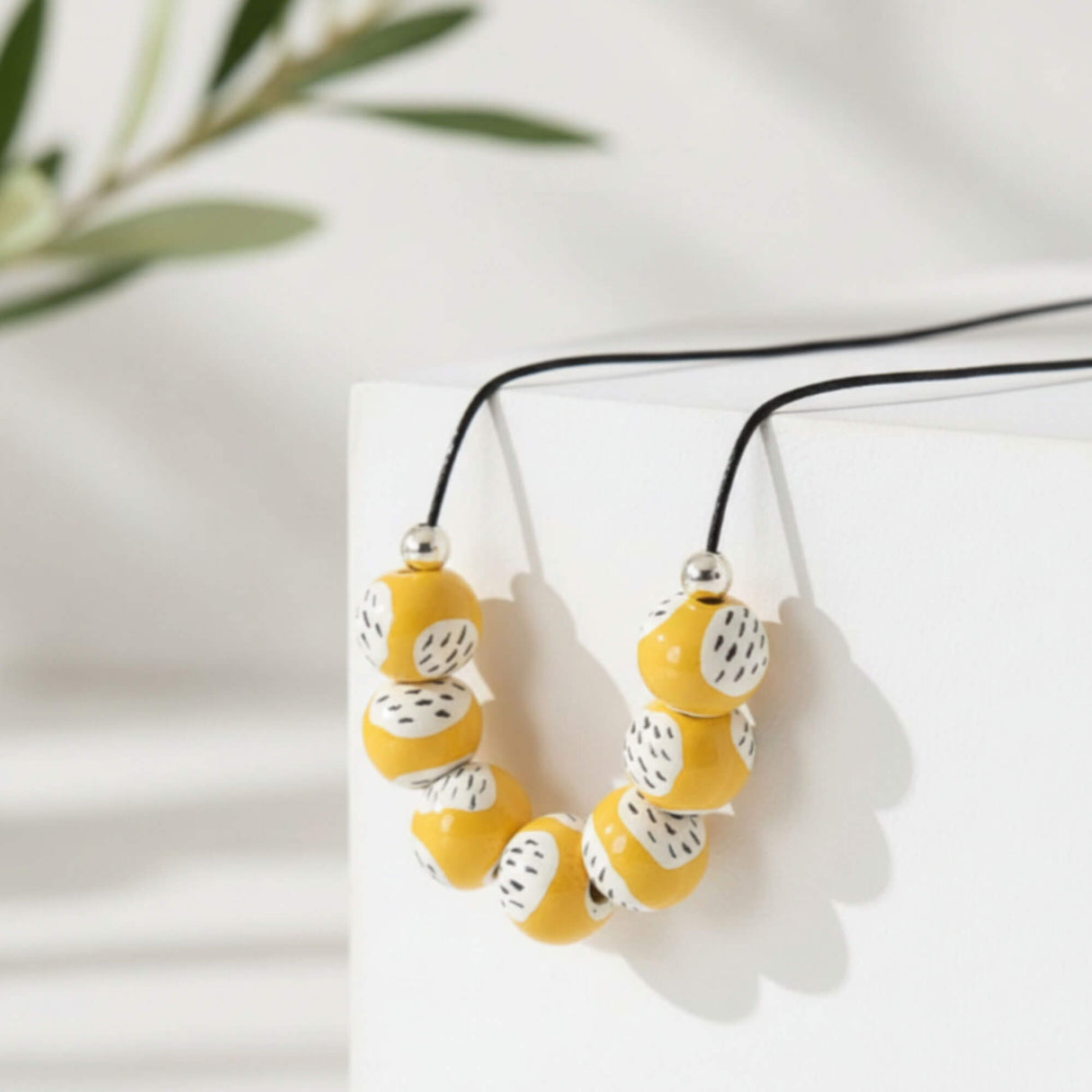 yellow statement bead necklace, handmade clay jewellery at lottie of london, lifestyle image