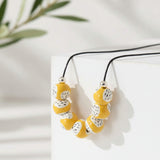 yellow statement bead necklace, handmade clay jewellery at lottie of london, lifestyle image