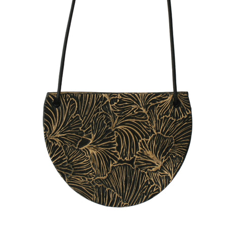 Black bib pendant necklace with gold ginkgo design